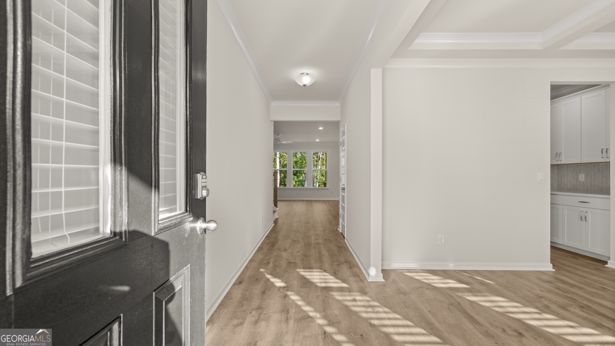 1816 Quaker Street Hampton, GA 30228 - Photo 2 of 32 a view of a hallway with wooden floor and a living room
