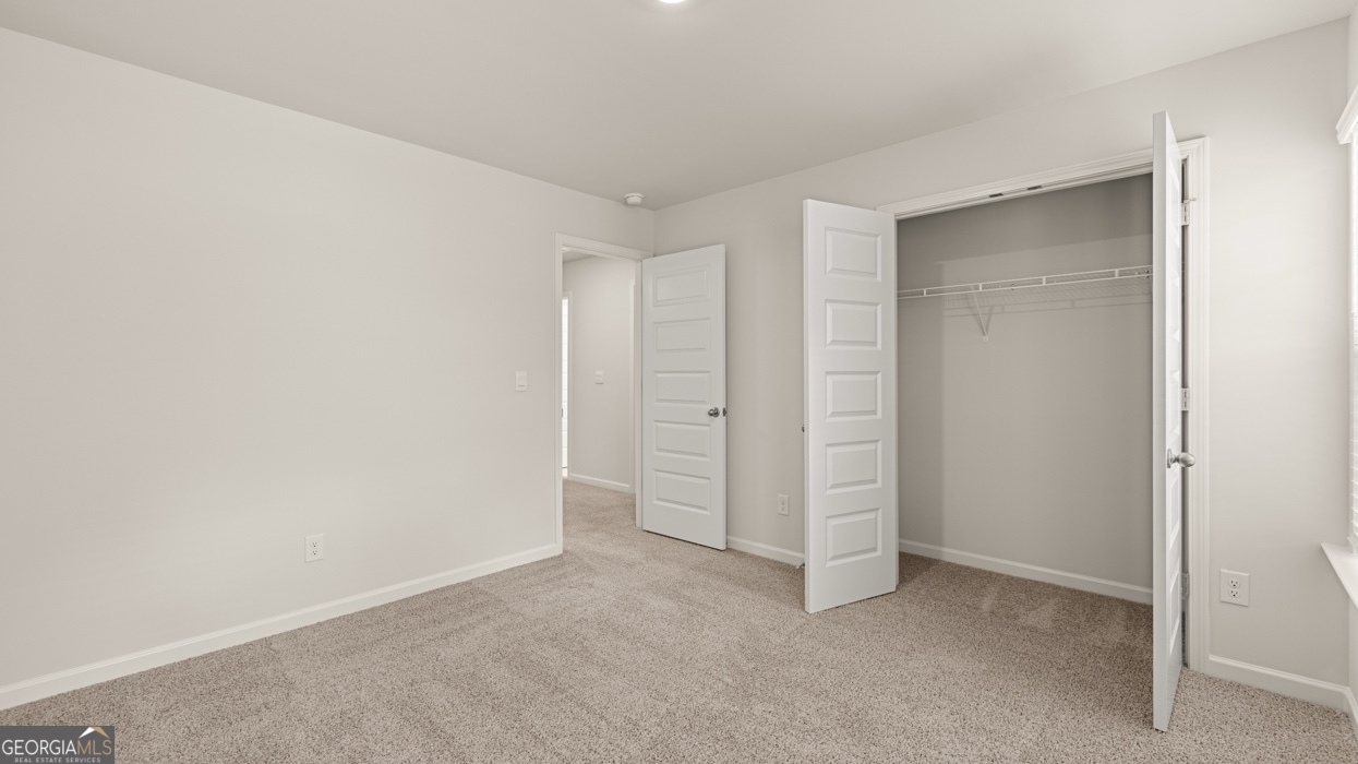 1816 Quaker Street Hampton, GA 30228 - Photo 23 of 32 an empty room with walk in closet and closet