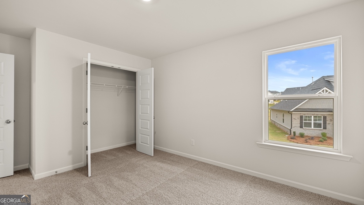 1816 Quaker Street Hampton, GA 30228 - Photo 24 of 32 an empty room with windows and closet