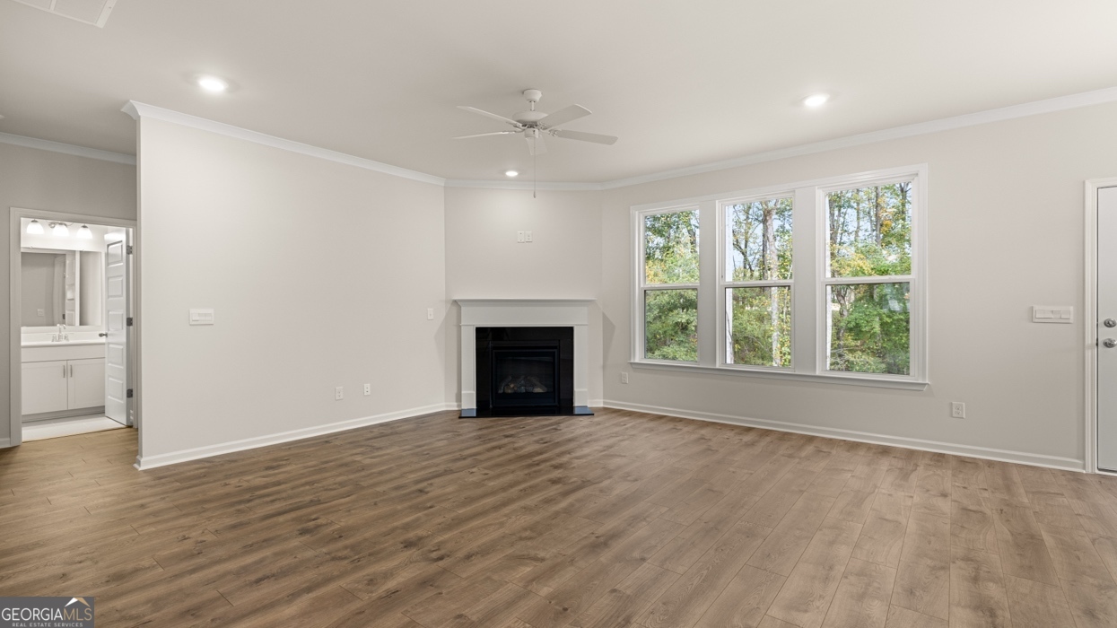 1816 Quaker Street Hampton, GA 30228 - Photo 9 of 32 an empty room with large windows and a fireplace