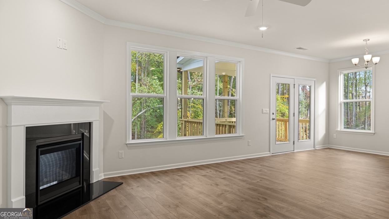 1816 Quaker Street Hampton, GA 30228 - Photo 10 of 32 a view of an empty room with wooden floor fireplace and a window