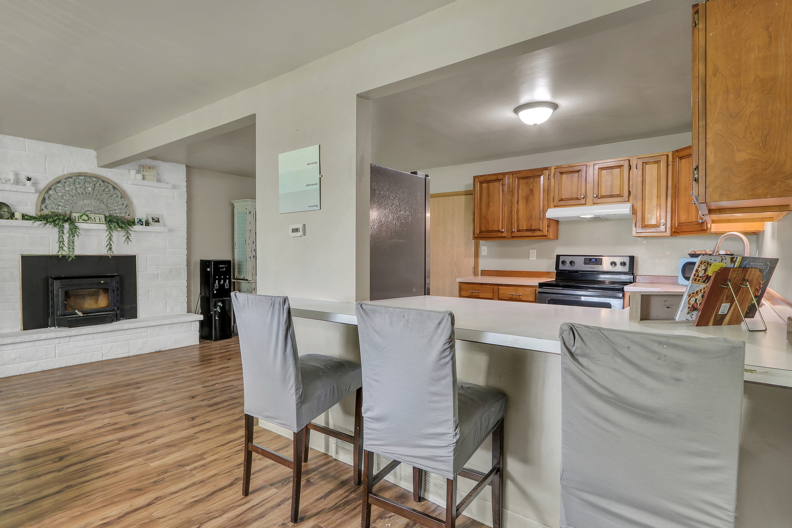 7120 East Tryon Grove Road Richmond, IL 60071 - Photo 19 of 33 a kitchen with stainless steel appliances granite countertop a stove top oven a counter space and cabinets