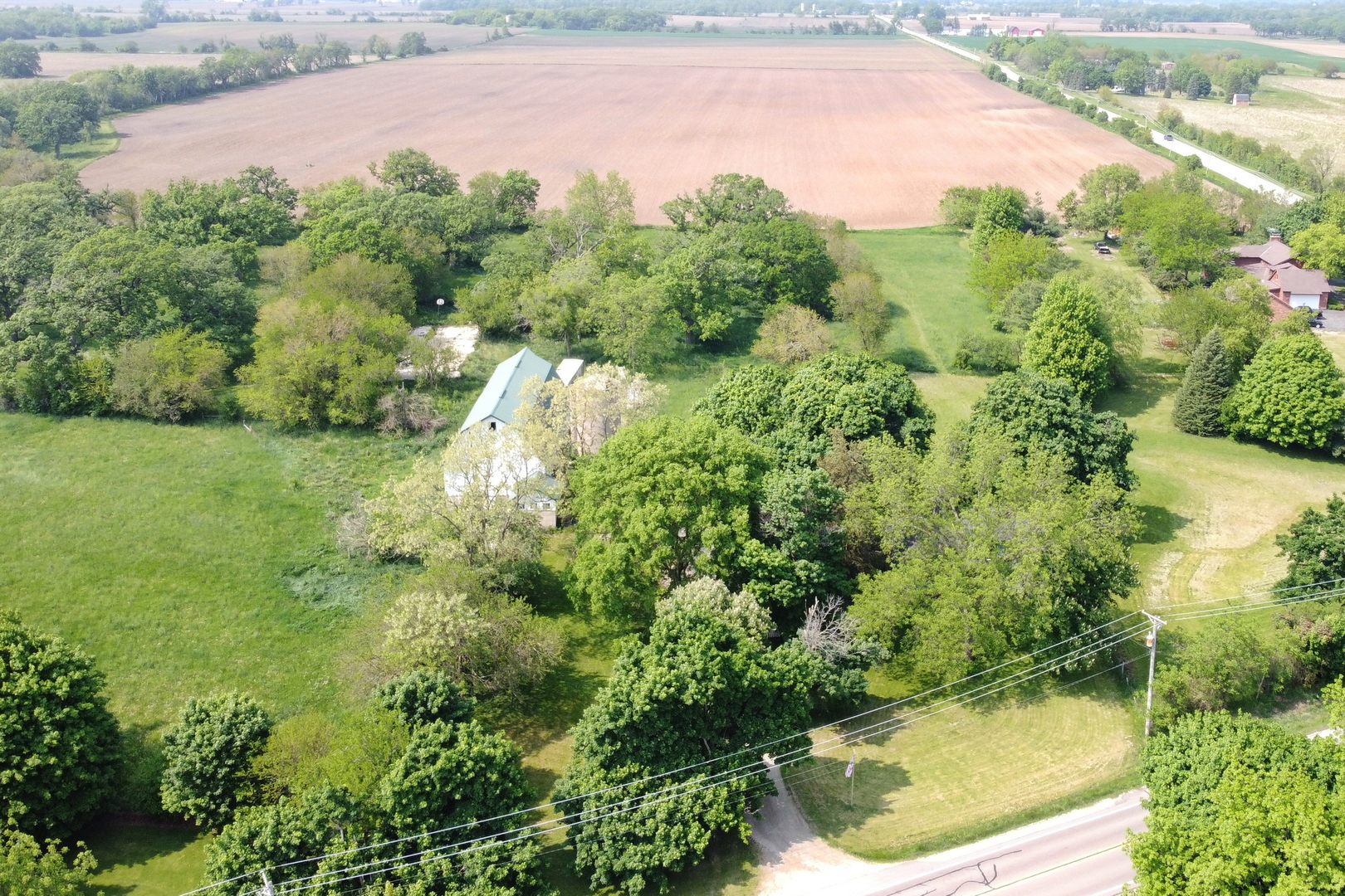 7120 East Tryon Grove Road Richmond, IL 60071 - Photo 3 of 33 an aerial view of residential house with outdoor space and trees around