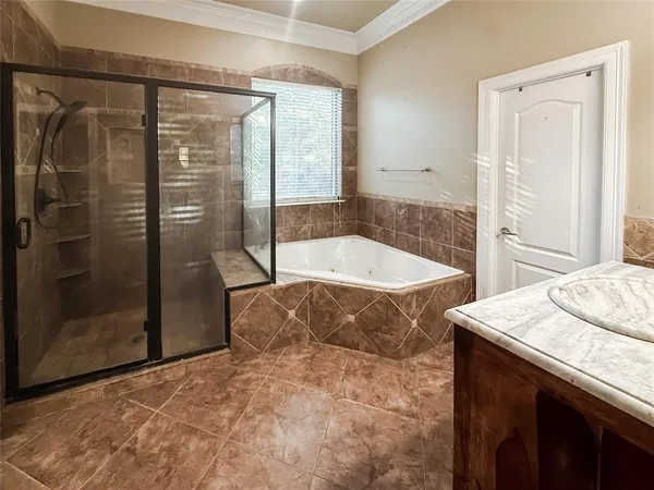 a bathroom with a tub and shower
