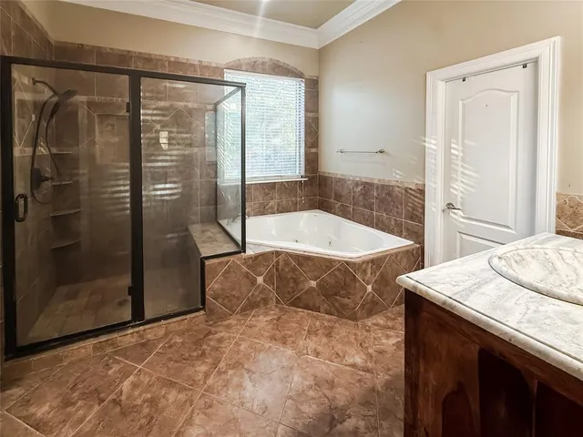 a bathroom with a tub and shower