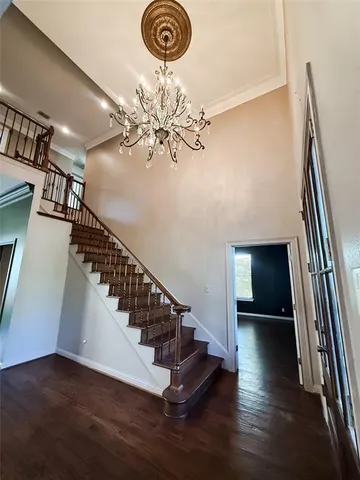 a view of entryway and hall with wooden floor