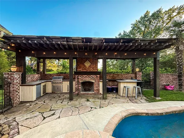 a patio with a table and chairs and potted plants
