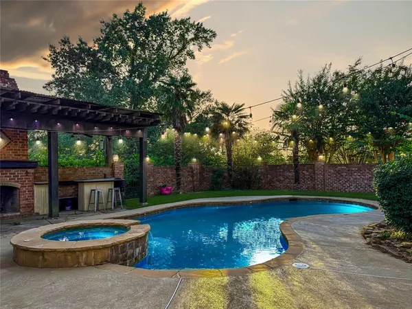 a view of a backyard with swimming pool and outdoor seating