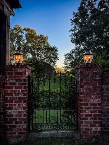 a view of a brick house with a tree in front of it