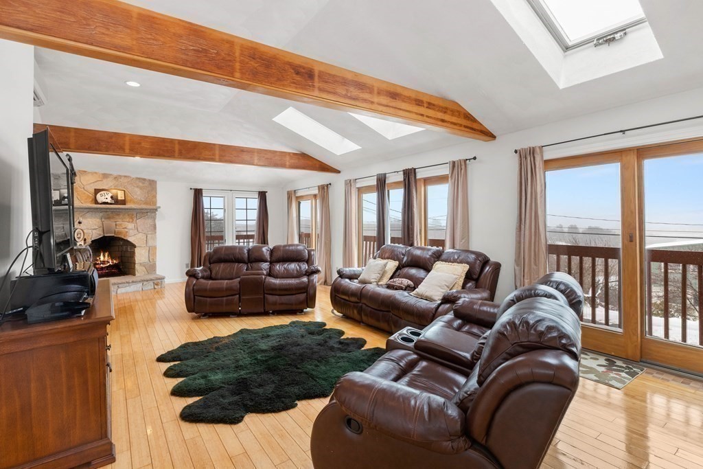 56 Skytop Road Ipswich, MA 01938 - Photo 11 of 42 a living room with furniture fireplace and a large window