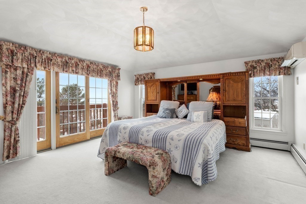 56 Skytop Road Ipswich, MA 01938 - Photo 13 of 42 a bed room with a bed and a large window
