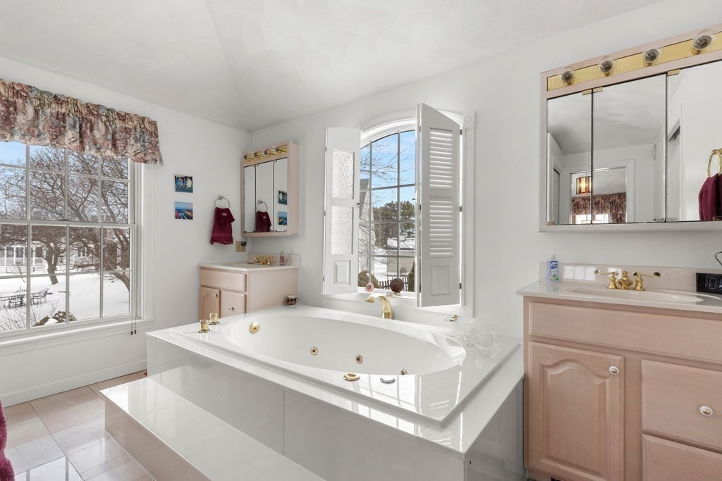 56 Skytop Road Ipswich, MA 01938 - Photo 15 of 42 a bathroom with a tub sink and mirror