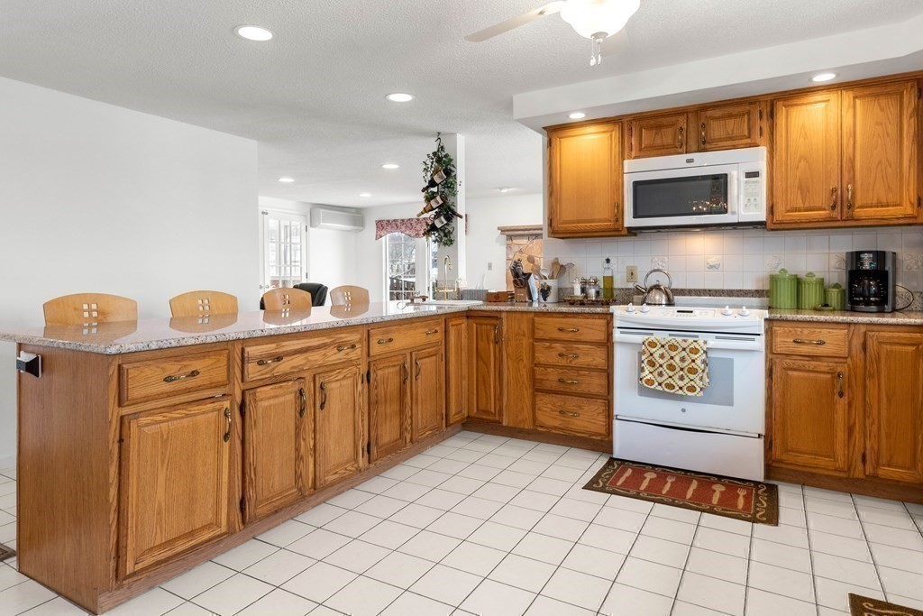 56 Skytop Road Ipswich, MA 01938 - Photo 23 of 42 a kitchen with stainless steel appliances granite countertop a sink and cabinets