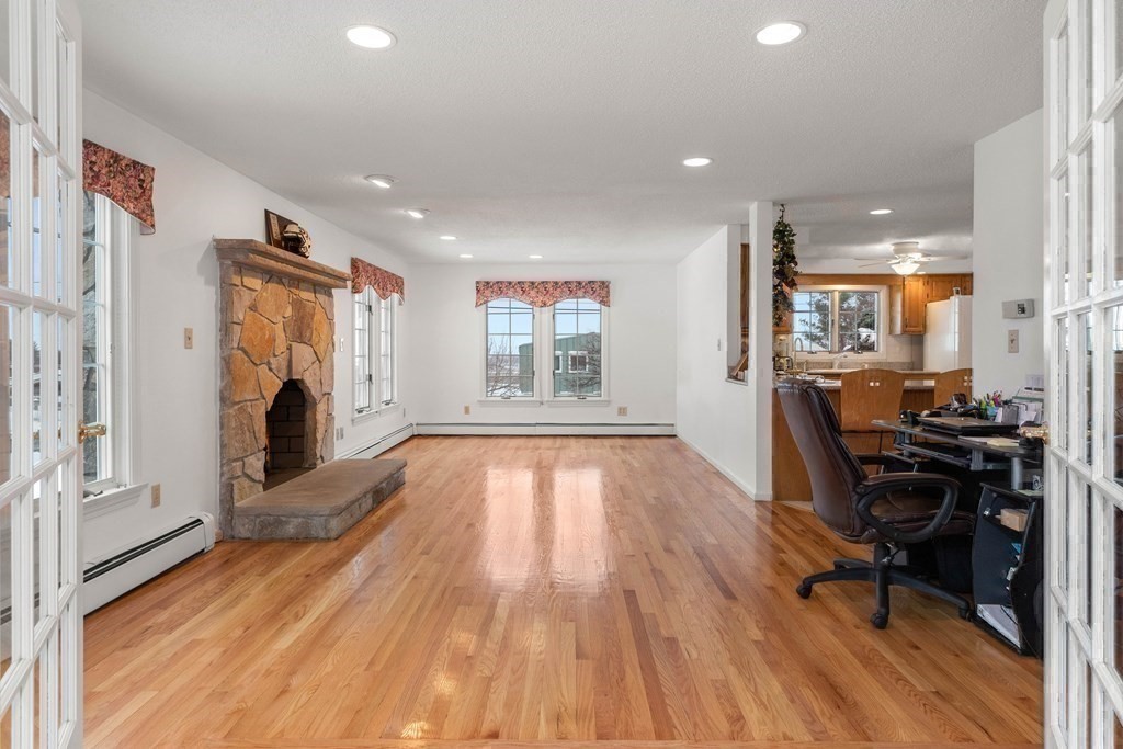 56 Skytop Road Ipswich, MA 01938 - Photo 25 of 42 a view of empty room with wooden floor and fireplace