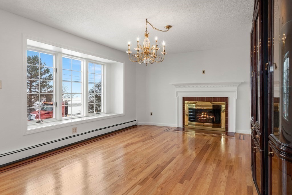 56 Skytop Road Ipswich, MA 01938 - Photo 30 of 42 a view of an empty room with a window and wooden floor