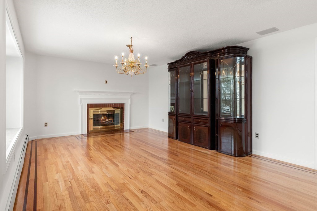 56 Skytop Road Ipswich, MA 01938 - Photo 31 of 42 wooden floor fireplace and natural light in room