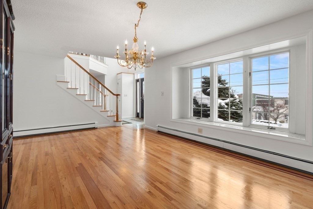 56 Skytop Road Ipswich, MA 01938 - Photo 32 of 42 a view of an empty room with wooden floor and a window