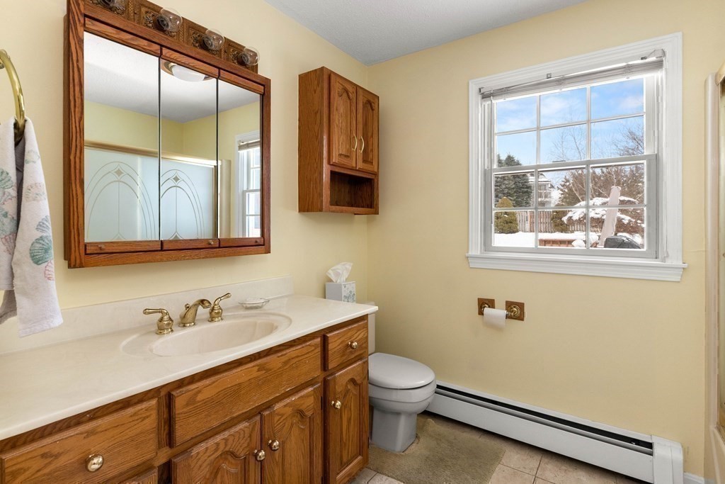 56 Skytop Road Ipswich, MA 01938 - Photo 33 of 42 a bathroom with a toilet sink and mirror