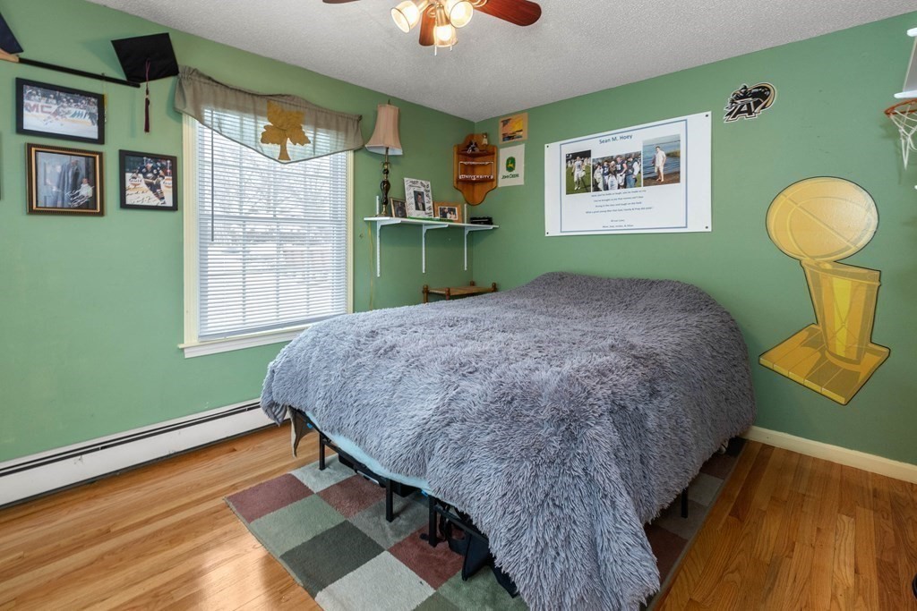 56 Skytop Road Ipswich, MA 01938 - Photo 34 of 42 a bed sitting in a bedroom next to a window