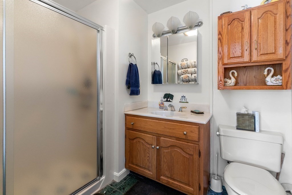 56 Skytop Road Ipswich, MA 01938 - Photo 36 of 42 a bathroom with a toilet sink and mirror