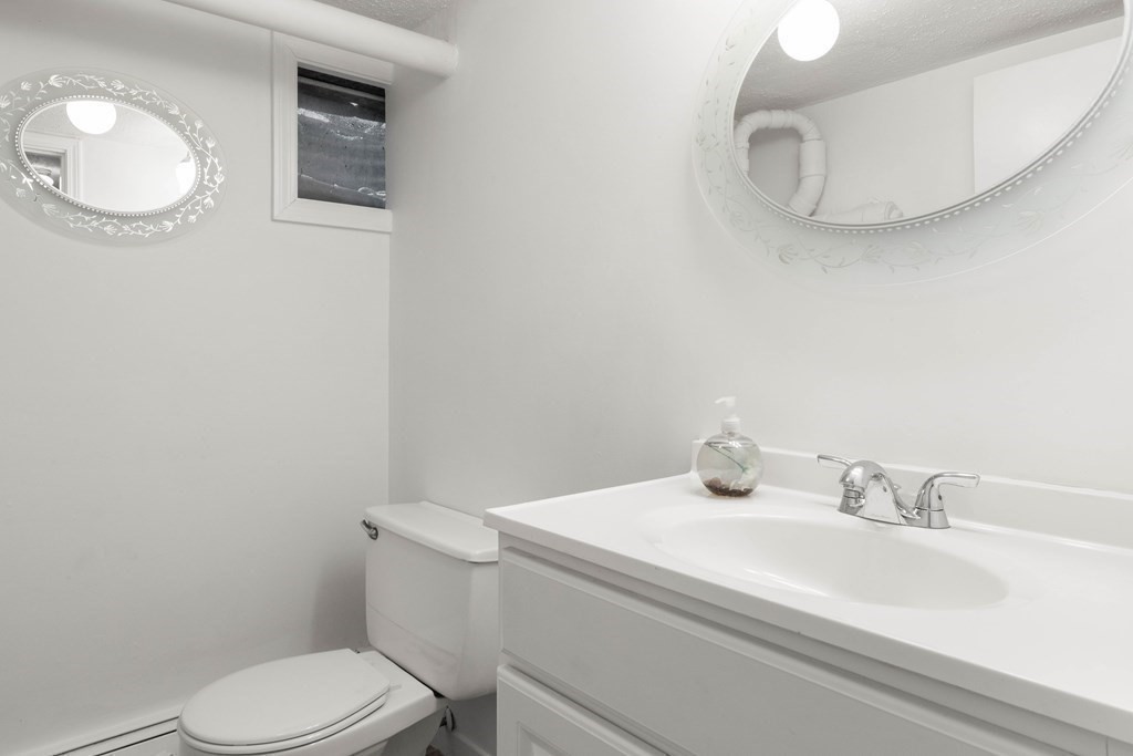 56 Skytop Road Ipswich, MA 01938 - Photo 41 of 42 a bathroom with a sink a toilet and mirror