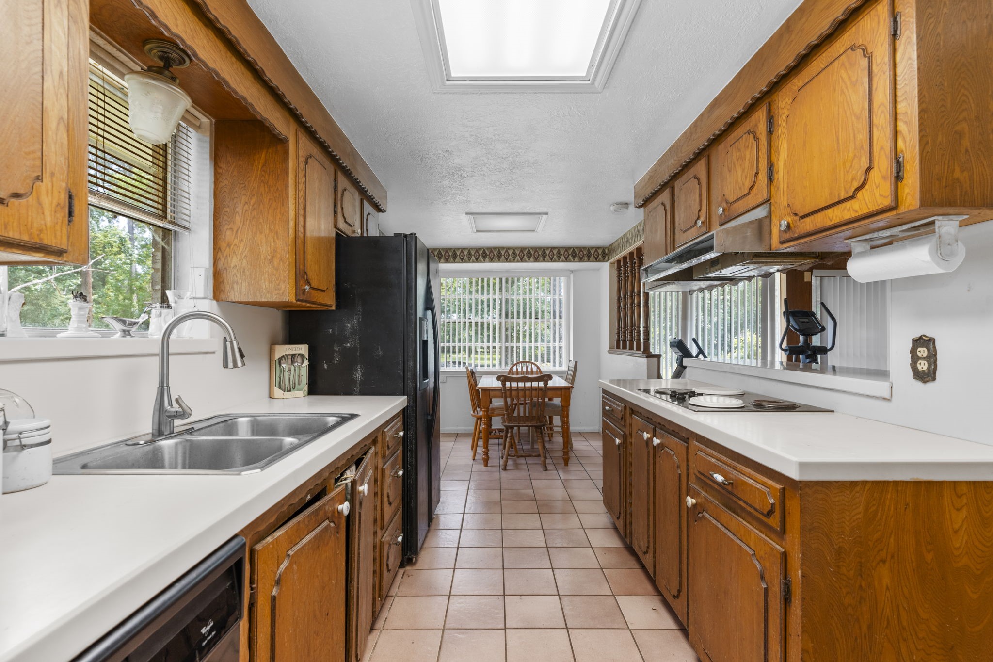 2395 Southline Road Conroe, TX 77384 - Photo 12 of 44 a kitchen with stainless steel appliances granite countertop sink stove top oven and cabinets