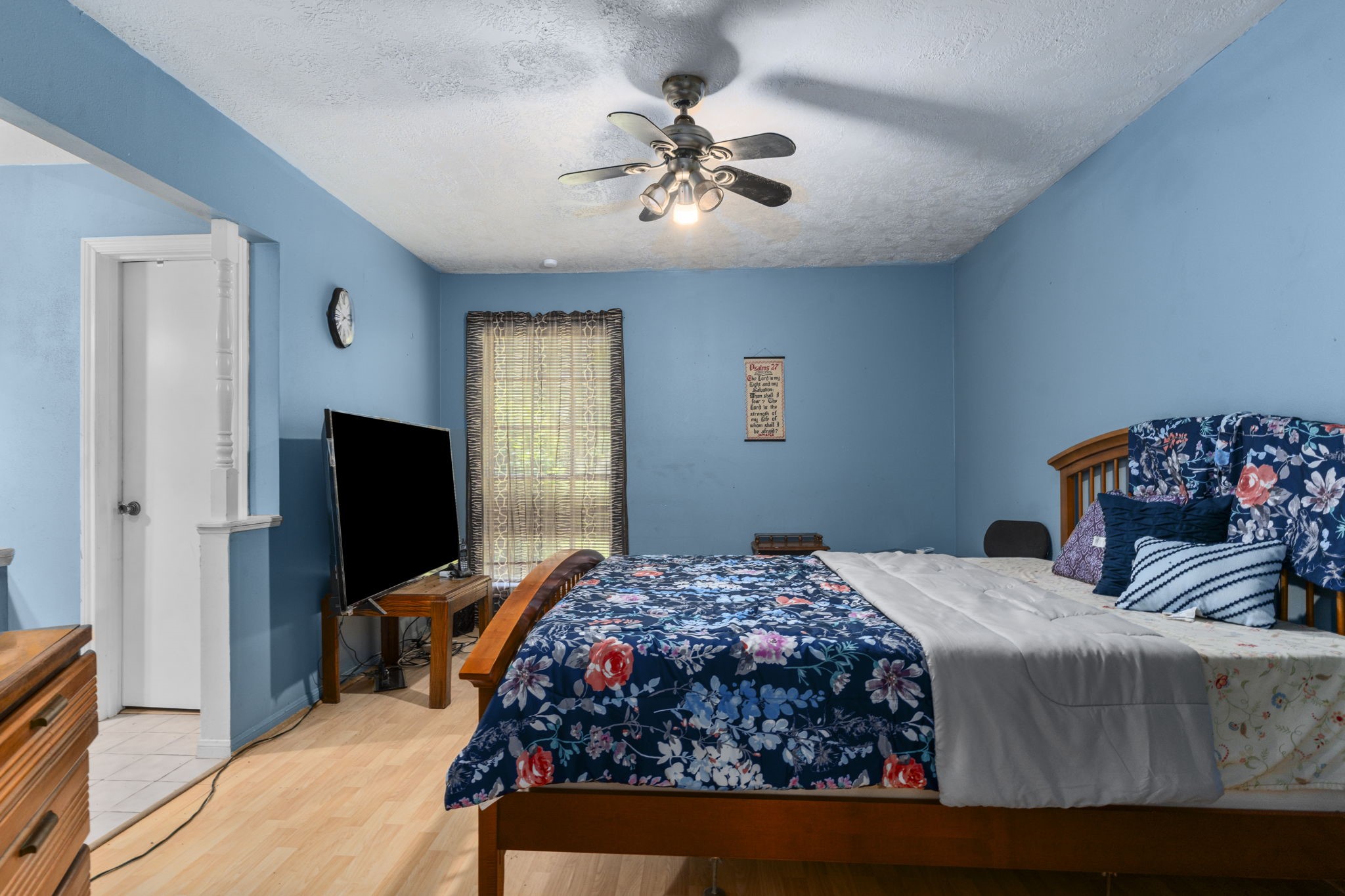 2395 Southline Road Conroe, TX 77384 - Photo 14 of 44 a bedroom with a bed and a flat screen tv