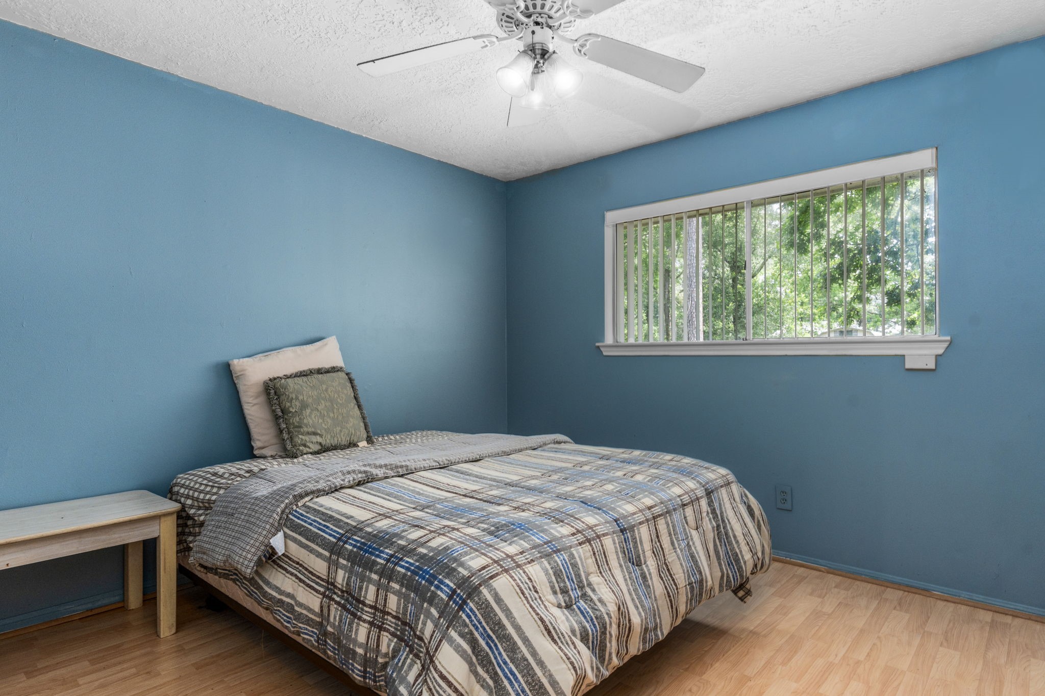 2395 Southline Road Conroe, TX 77384 - Photo 17 of 44 a bedroom with a large bed and a chandelier