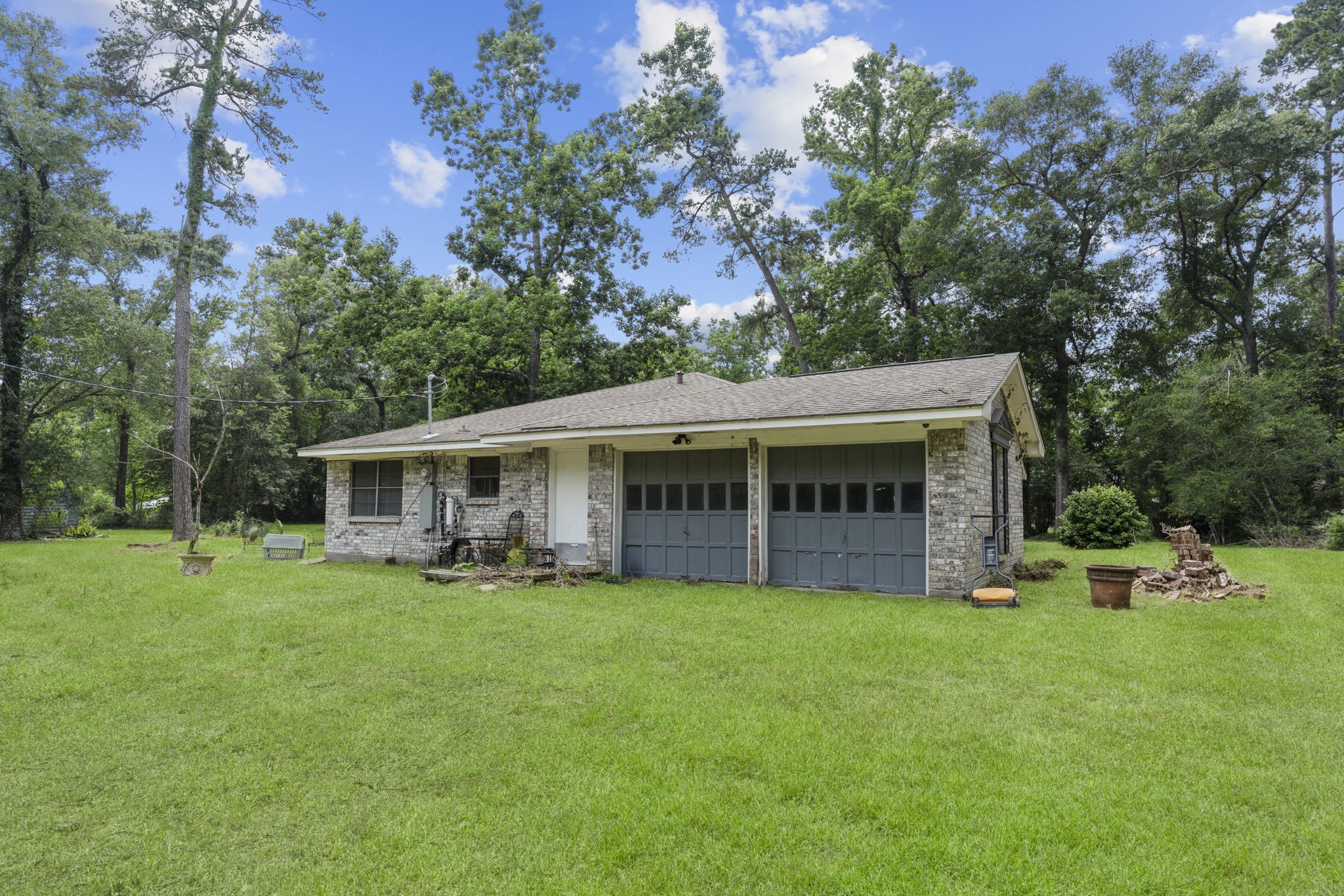 2395 Southline Road Conroe, TX 77384 - Photo 2 of 44 a view of a house with a yard and sitting area