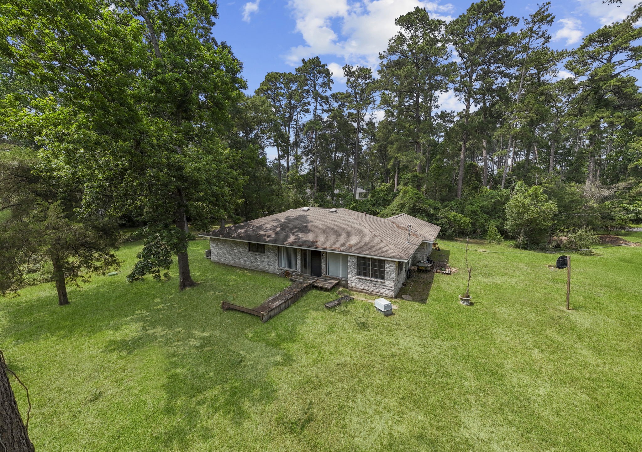 2395 Southline Road Conroe, TX 77384 - Photo 28 of 44 a view of a house with a yard and sitting area