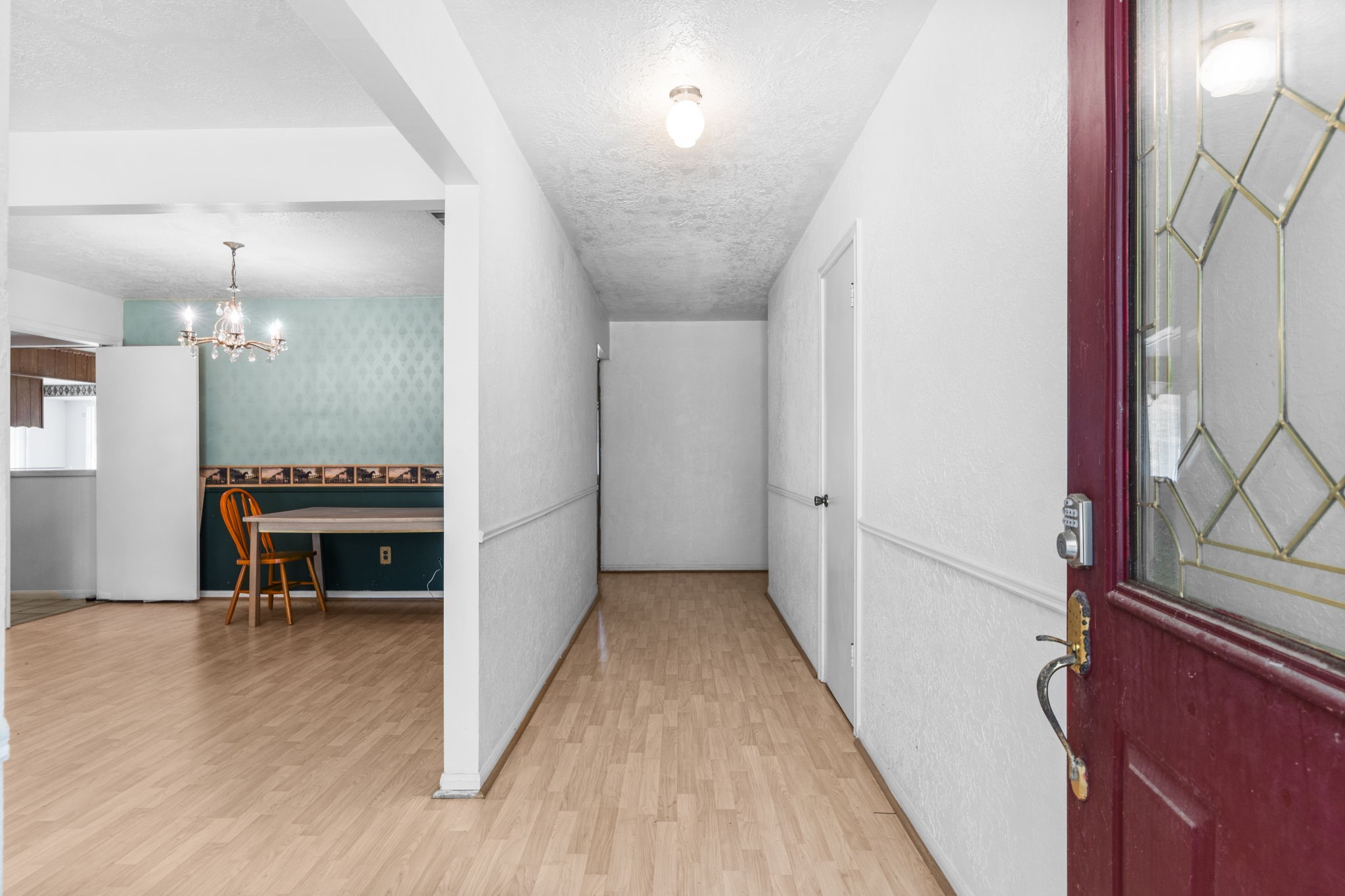 2395 Southline Road Conroe, TX 77384 - Photo 3 of 44 a view of a hallway with wooden floor and a kitchen