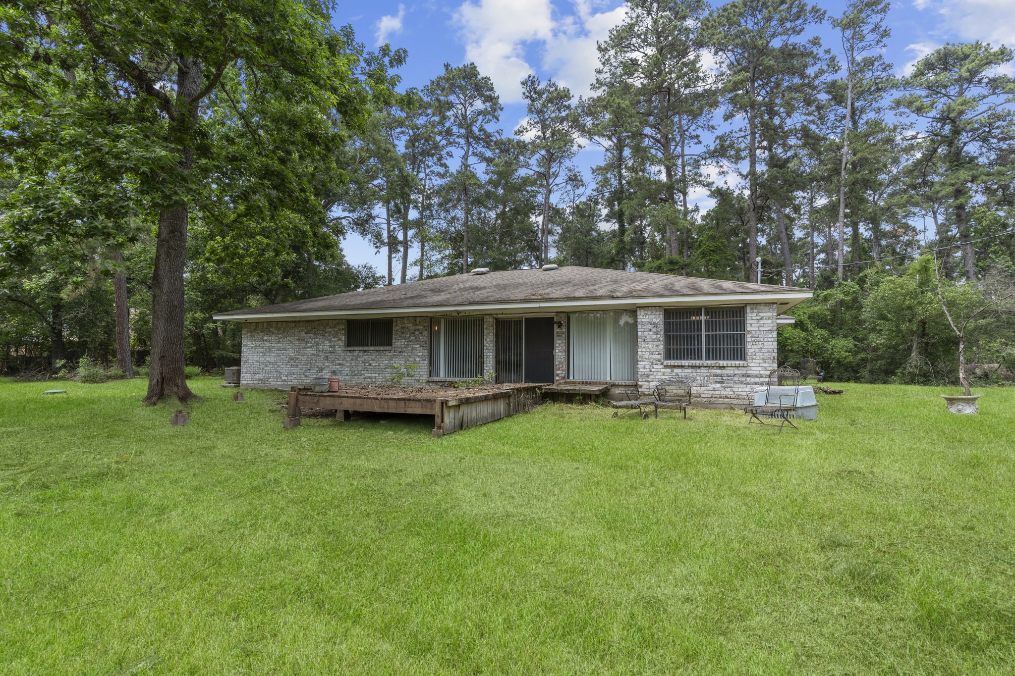 2395 Southline Road Conroe, TX 77384 - Photo 31 of 44 a view of a house with a backyard