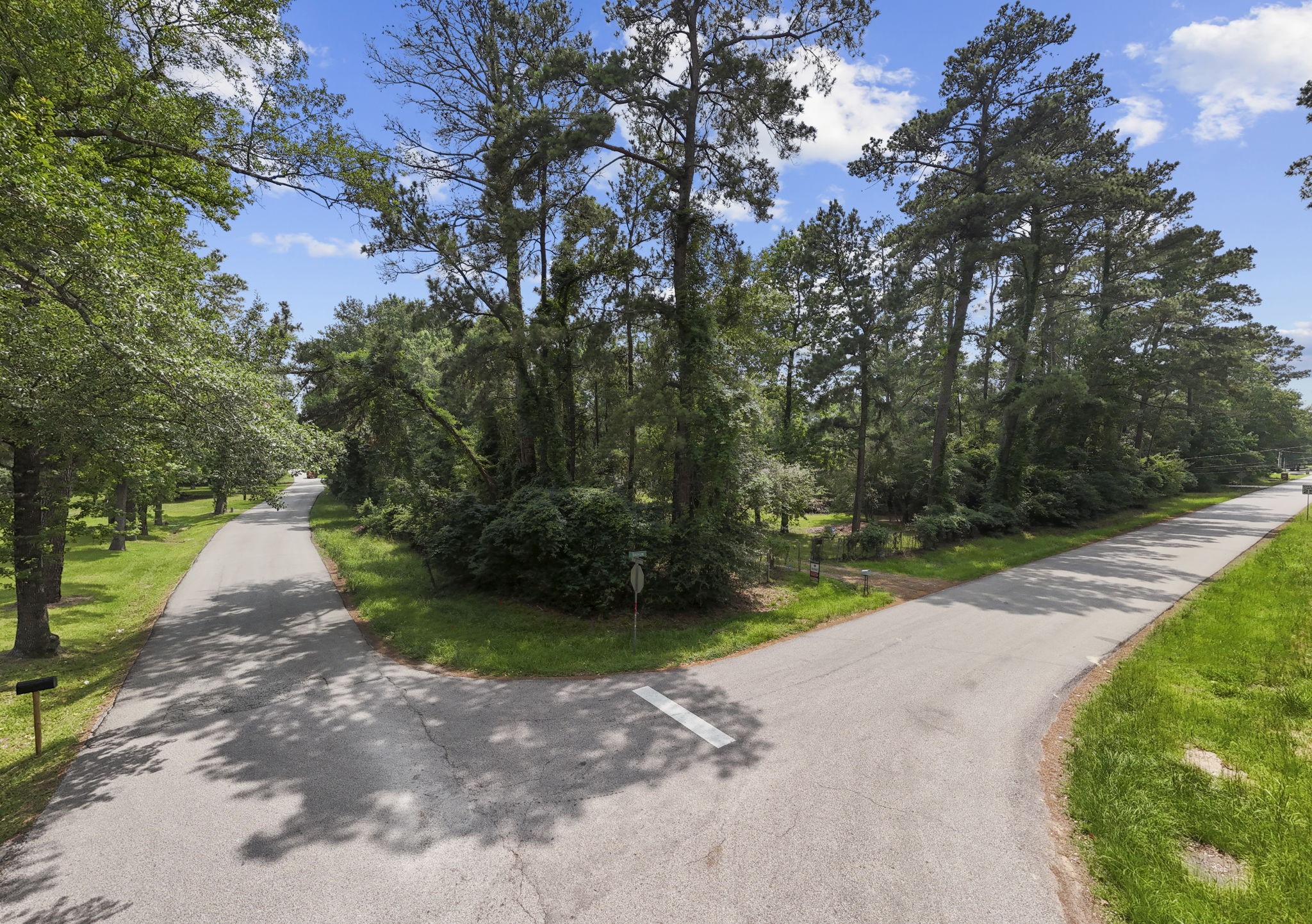 2395 Southline Road Conroe, TX 77384 - Photo 32 of 44 a view of a road with a yard