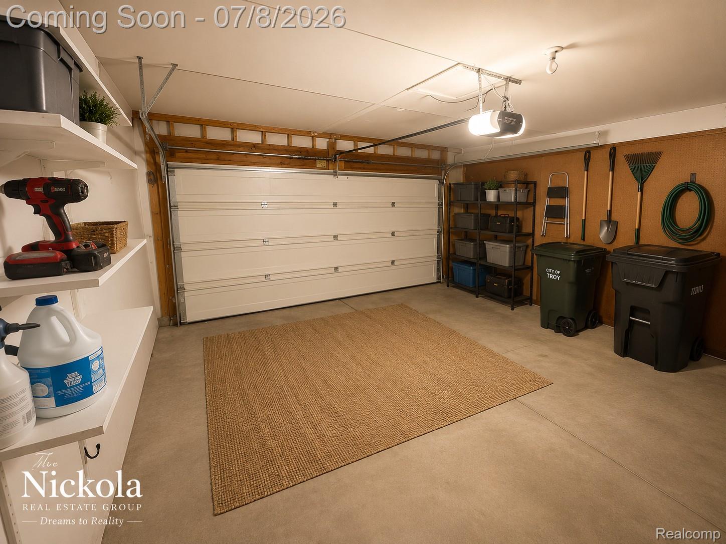 414 Whitney Drive Rochester, MI 48307 - Photo 30 of 30 Garage featuring a single overhead door, built-in shelving, concrete flooring, and a pegboard wall