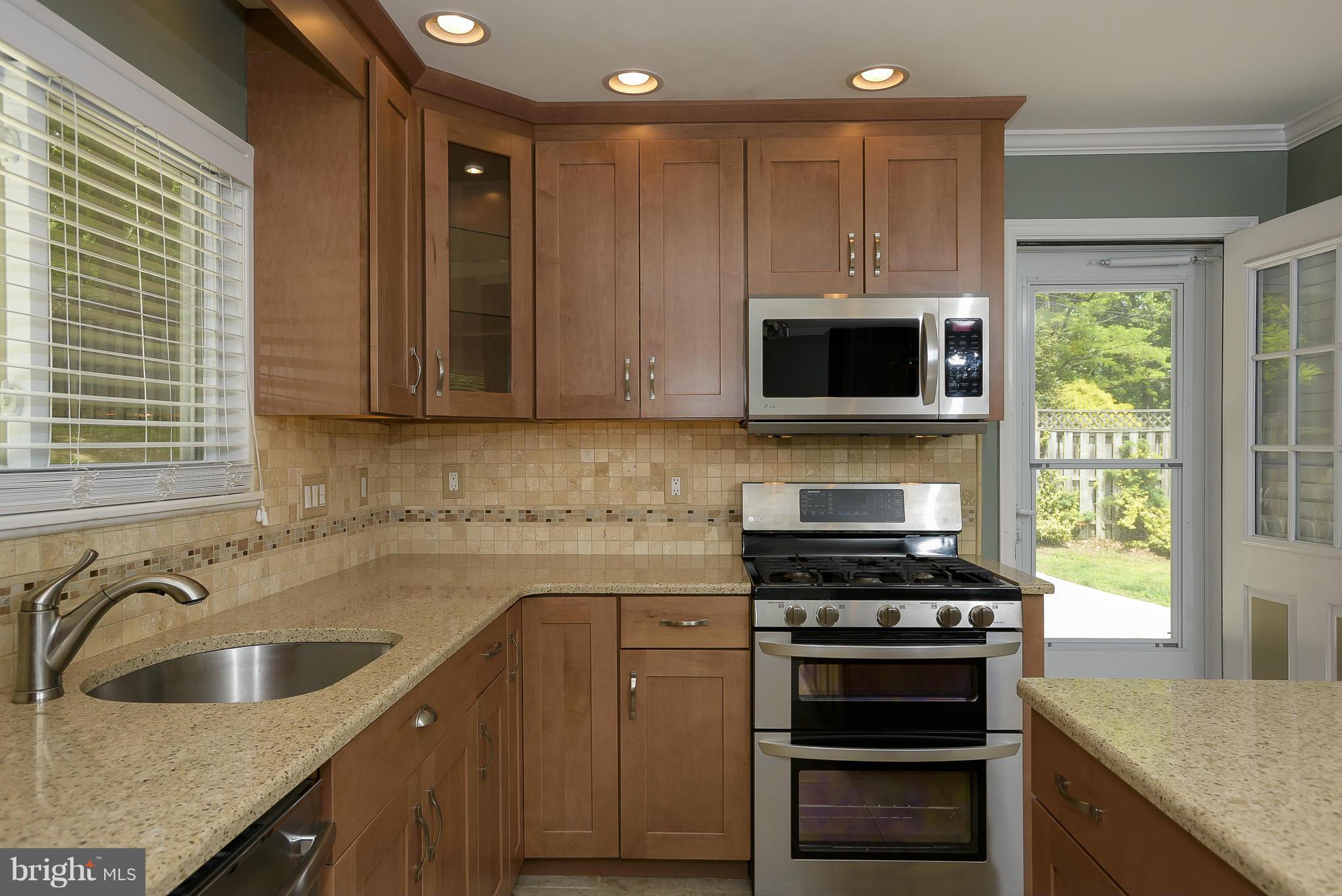 100 Shortcross Road Linthicum Heights, MD 21090 - Photo 11 of 30 a kitchen with granite countertop a sink and a stove top oven