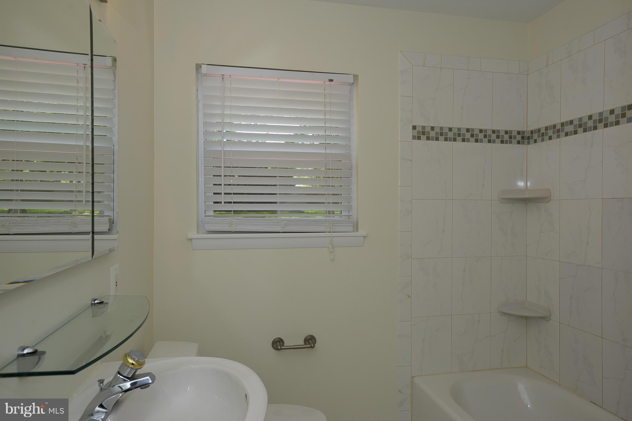 100 Shortcross Road Linthicum Heights, MD 21090 - Photo 13 of 30 a bathroom with a sink a toilet and shower