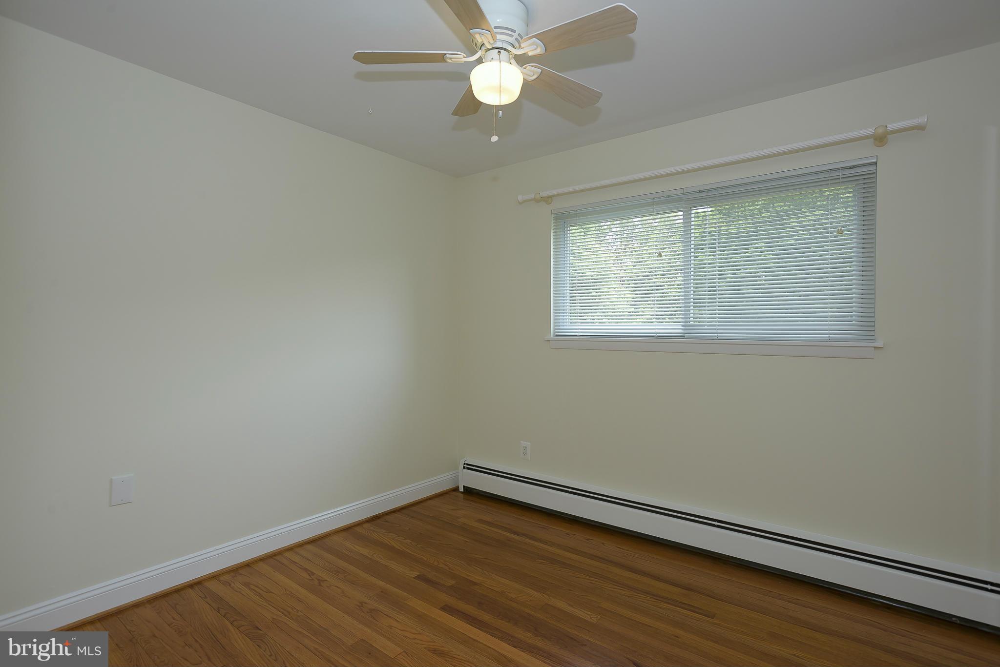 100 Shortcross Road Linthicum Heights, MD 21090 - Photo 16 of 30 an empty room with wooden floor and windows