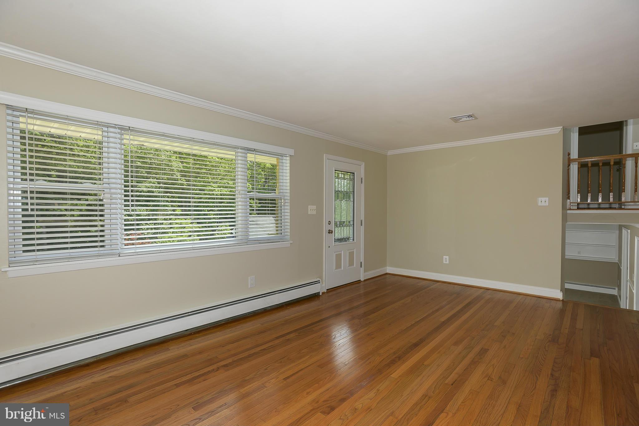 100 Shortcross Road Linthicum Heights, MD 21090 - Photo 3 of 30 wooden floor in an empty room with a window