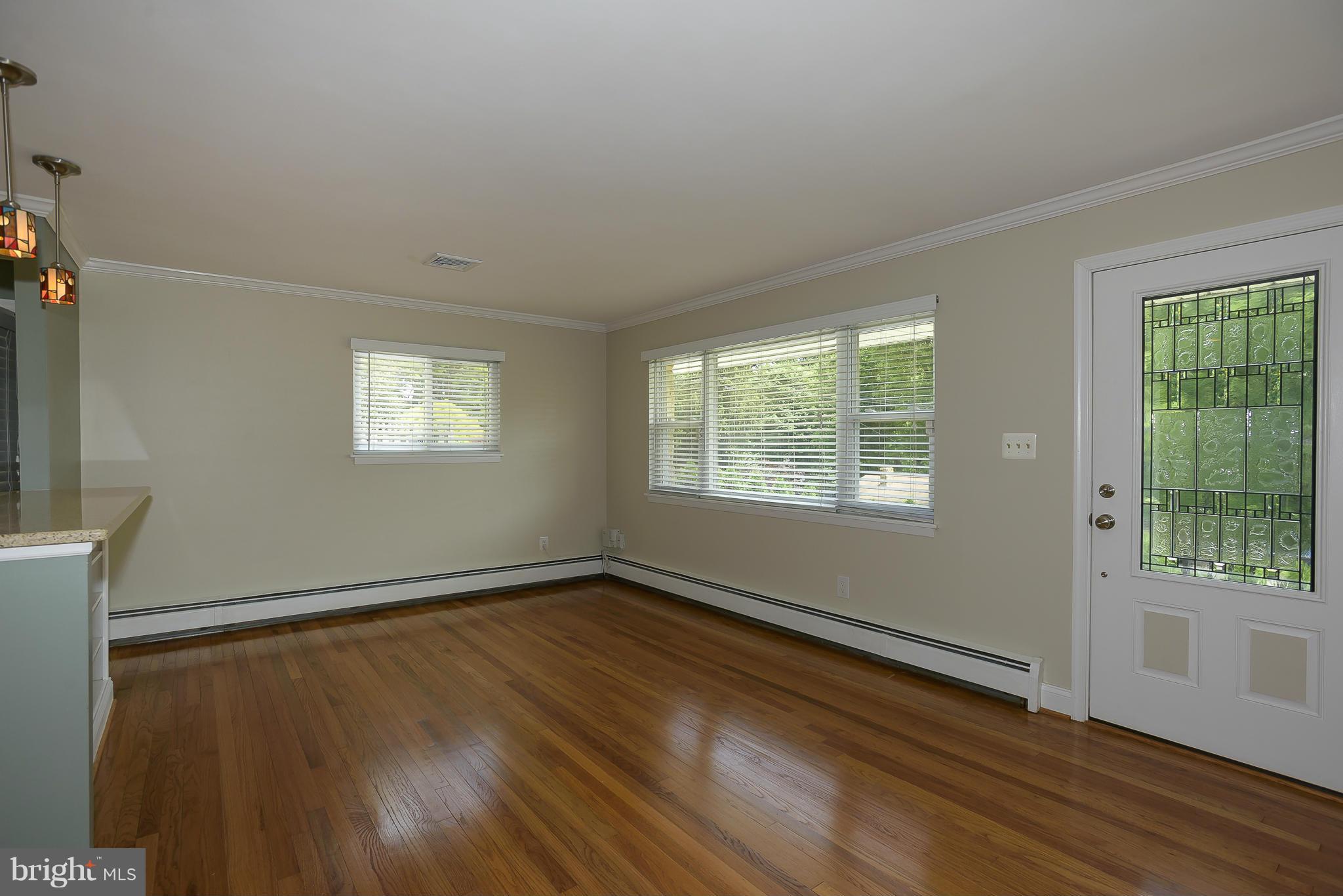 100 Shortcross Road Linthicum Heights, MD 21090 - Photo 5 of 30 a view of an empty room with wooden floor and a window