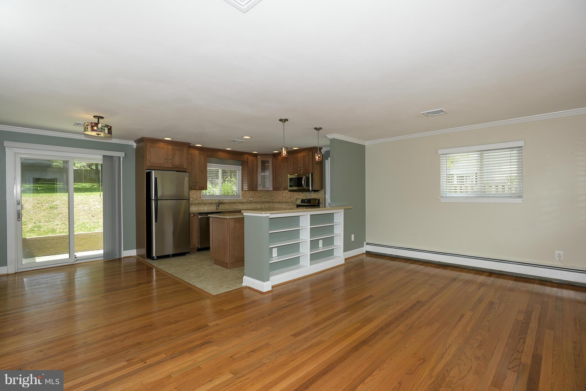 100 Shortcross Road Linthicum Heights, MD 21090 - Photo 7 of 30 an empty room with wooden floor and windows