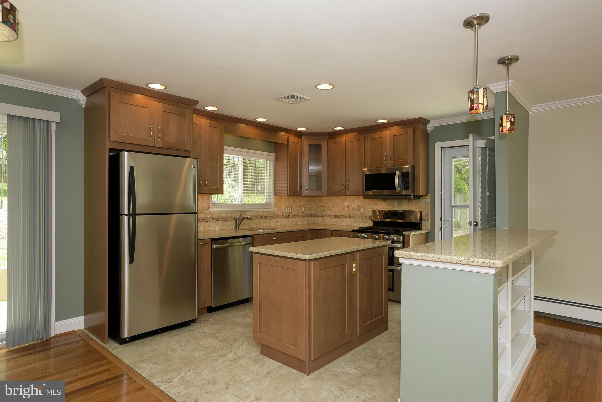 100 Shortcross Road Linthicum Heights, MD 21090 - Photo 10 of 30 a kitchen with stainless steel appliances granite countertop a refrigerator a stove and a sink