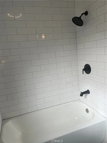 a bathroom with a granite countertop toilet a sink and a mirror