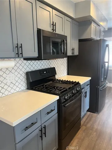 a kitchen with granite countertop a stove and a microwave