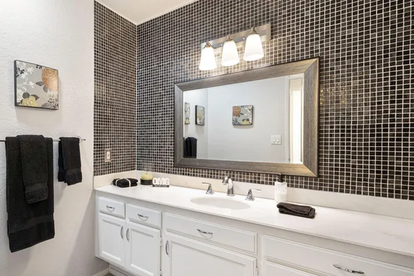 a bathroom with a sink and a mirror