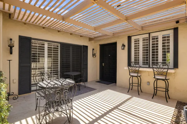 a balcony with furniture and a potted plant