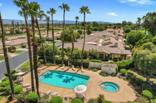 an aerial view of a house with a swimming pool patio and outdoor seating
