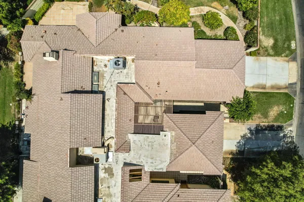an aerial view of a house with a yard