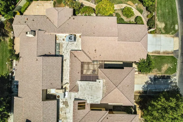 an aerial view of a house with a yard