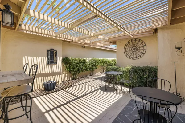 a view of a patio with a table and chairs