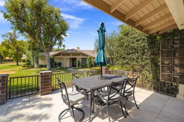 a view of a patio with a table and chairs